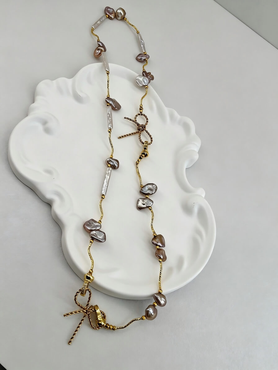 The Aphrodite Bow & Iridescent Baroque Pearl Necklace